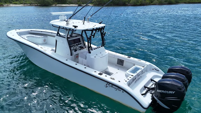 Slide: The Image of 2017 Yellowfin 36 Offshore boat with triple Mercury engines on blue water. - 12