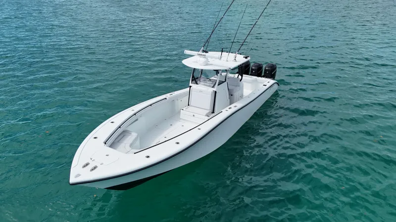 Slide: The Image of 2017 Yellowfin 36 Offshore boat on clear blue water, featuring triple outboard engines. - 13