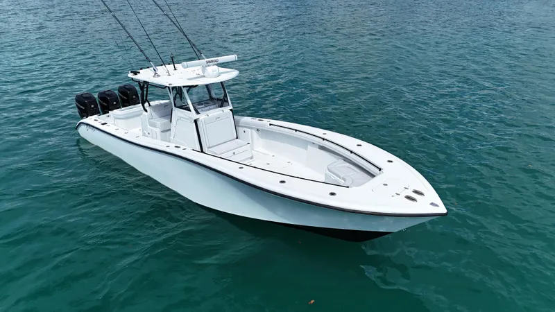 Slide: The Image of 2017 Yellowfin 36 Offshore boat on clear blue water, equipped with multiple outboard engines. - 17