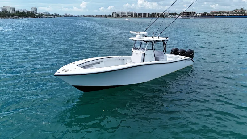 Slide: The Image of 2017 Yellowfin 36 Offshore boat on calm blue water, cityscape in background. - 19