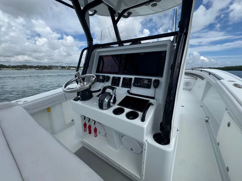 Slide: The Image of 2017 Yellowfin 36 Offshore boat cockpit with steering wheel and navigation equipment. - 23