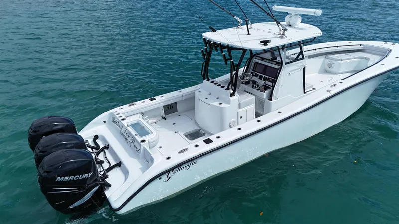 Slide: The Image of 2017 Yellowfin 36 Offshore boat with triple Mercury engines on blue water. - 24