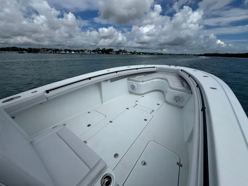 Slide: The Image of 2017 Yellowfin 36 Offshore boat with spacious deck and seating, under cloudy sky. - 25