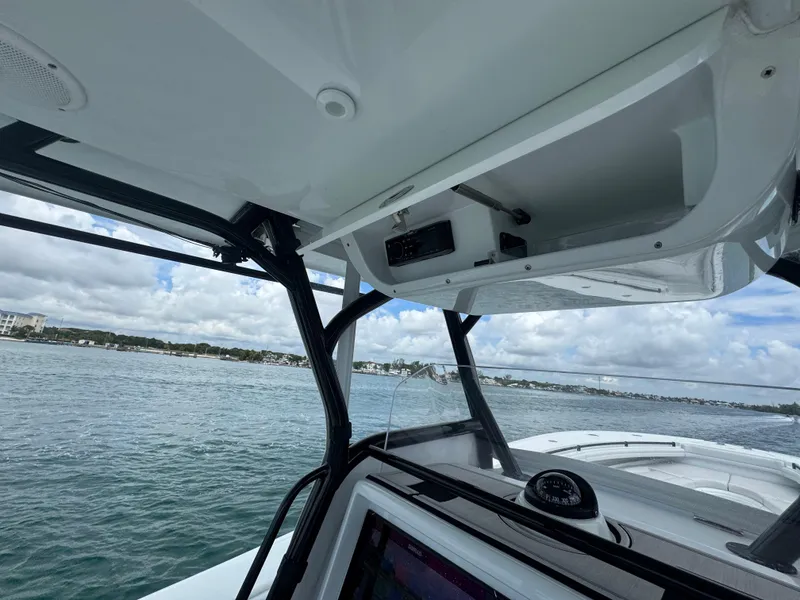 Slide: The Image of 2017 Yellowfin 36 Offshore boat interior with open storage compartment, ocean view in background. - 27