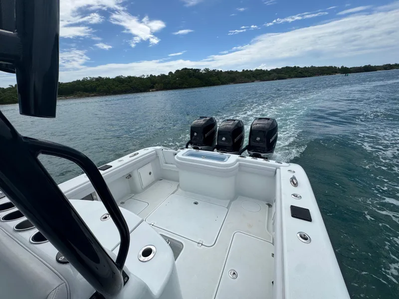 Slide: The Image of 2017 Yellowfin 36 Offshore boat with triple engines cruising on open water. - 31