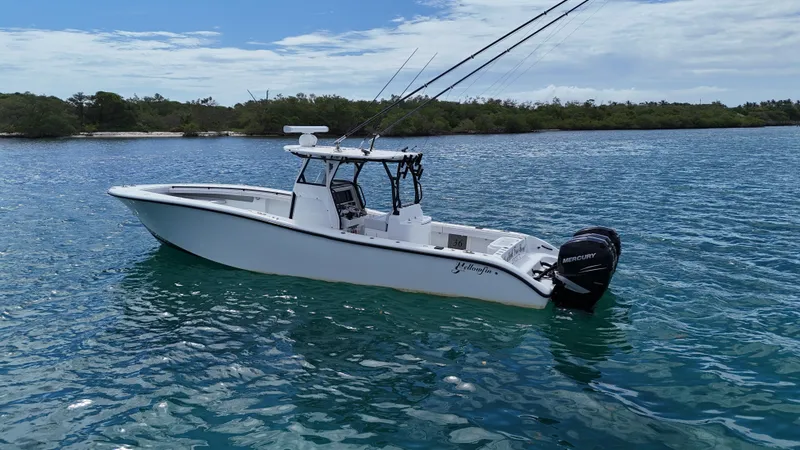 Slide: The Image of 2017 Yellowfin 36 Offshore boat on calm blue water, equipped with Mercury engines. - 8