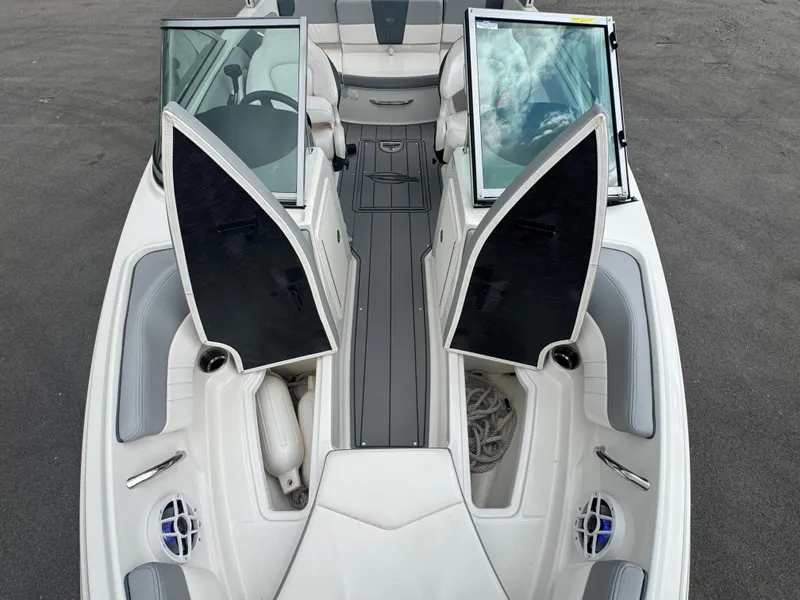 Slide: The Image of 2021 Chaparral 19 SSI Sport boat interior with open storage compartments and seating. - 11