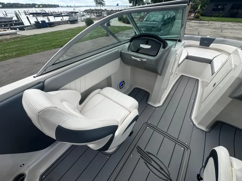 Slide: The Image of 2021 Chaparral 19 SSI Sport boat interior with sleek seating and modern dashboard design. - 13
