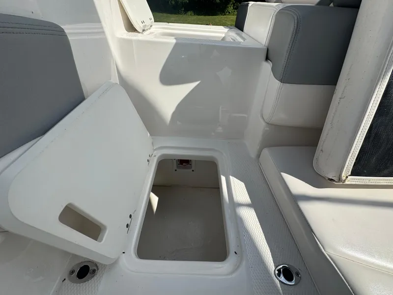 Slide: The Image of 2021 Chaparral 19 SSI Sport boat interior storage compartment with open lid. - 6