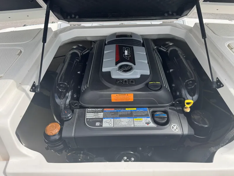 Slide: The Image of Engine compartment of a 2021 Chaparral 19 SSI Sport boat, featuring a Mercury 4.5L engine. - 9