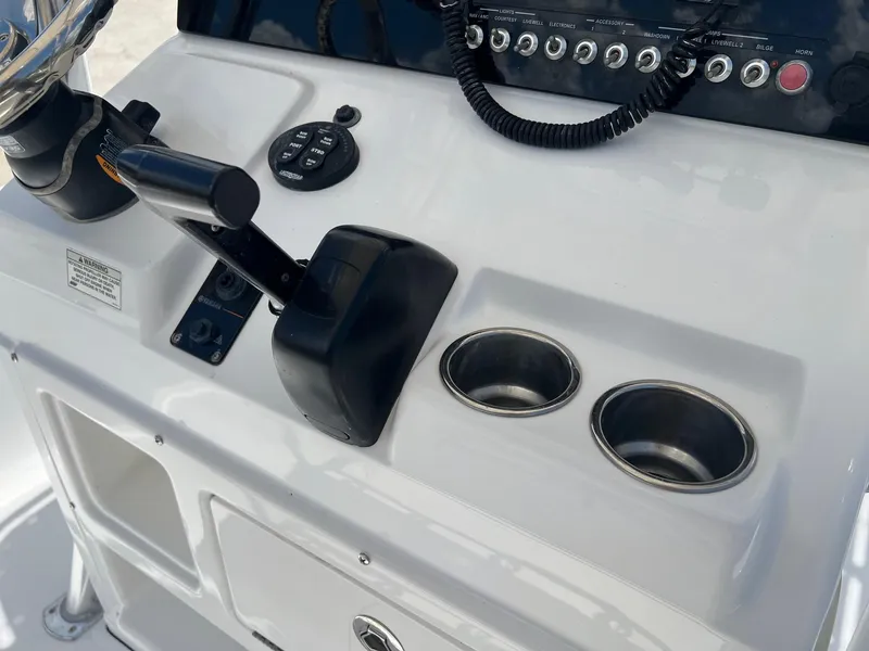 Slide: The Image of Control panel of a 2015 Sportsman Masters 247 Bay Boat with cup holders and switches. - 11