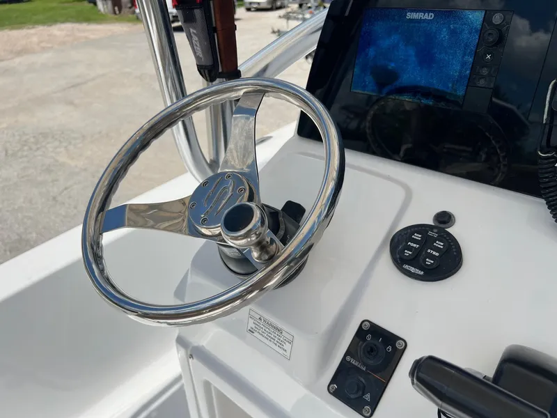 Slide: The Image of Steering wheel and controls of a 2015 Sportsman Masters 247 Bay Boat with Simrad display. - 12