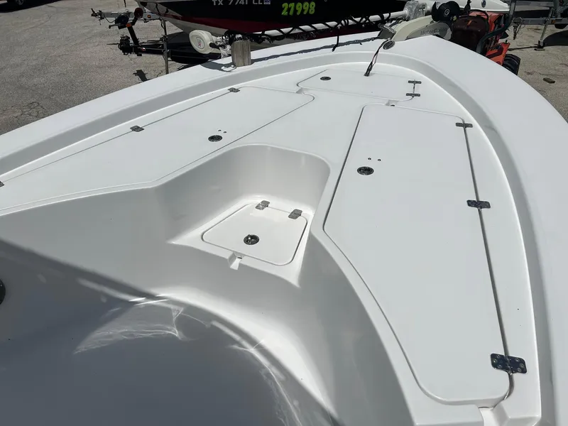Slide: The Image of 2015 Sportsman Masters 247 Bay Boat deck with storage compartments and clean white finish. - 14