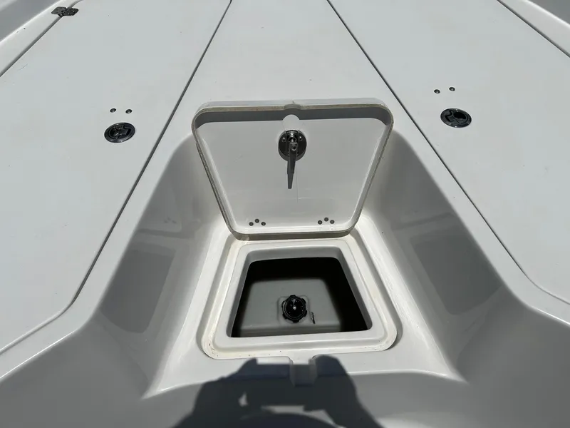 Slide: The Image of 2015 Sportsman Masters 247 Bay Boat storage compartment, open lid, white interior. - 17