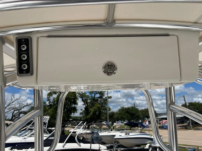 Slide: The Image of 2015 Sportsman Masters 247 Bay Boat T-top with control panel and storage compartment. - 19