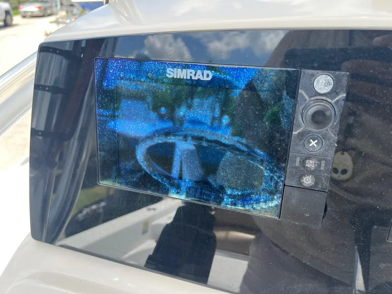 Slide: The Image of Simrad display on 2015 Sportsman Masters 247 Bay Boat, showing steering wheel reflection. - 21