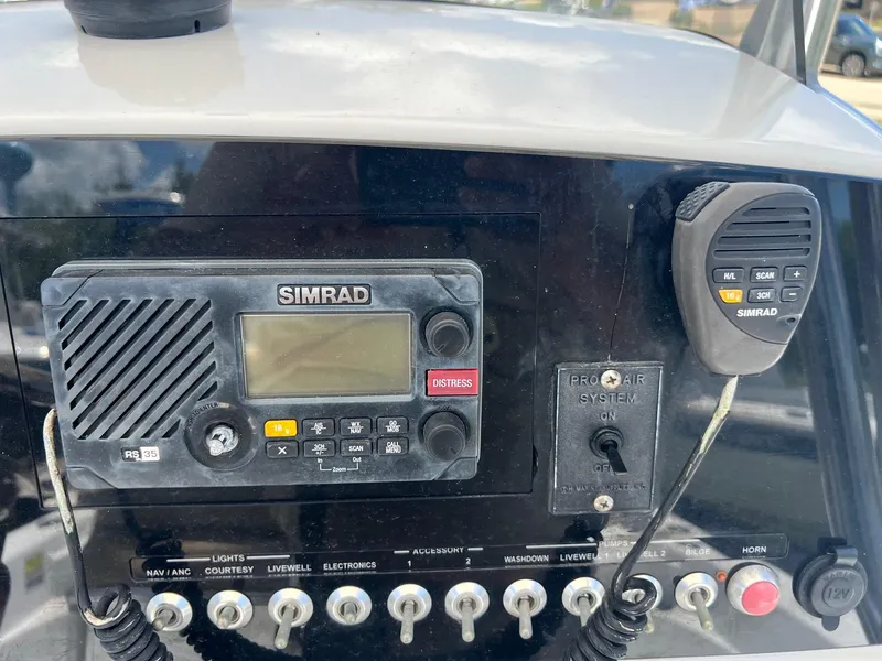 Slide: The Image of Control panel of a 2015 Sportsman Masters 247 Bay Boat with Simrad radio equipment. - 22