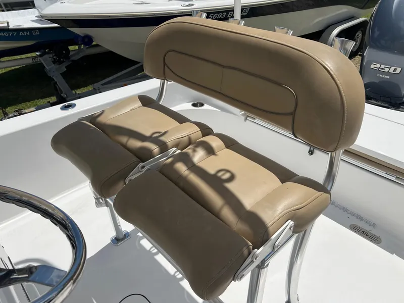 Slide: The Image of 2015 Sportsman Masters 247 Bay Boat with tan cushioned seating and stainless steel frame. - 24
