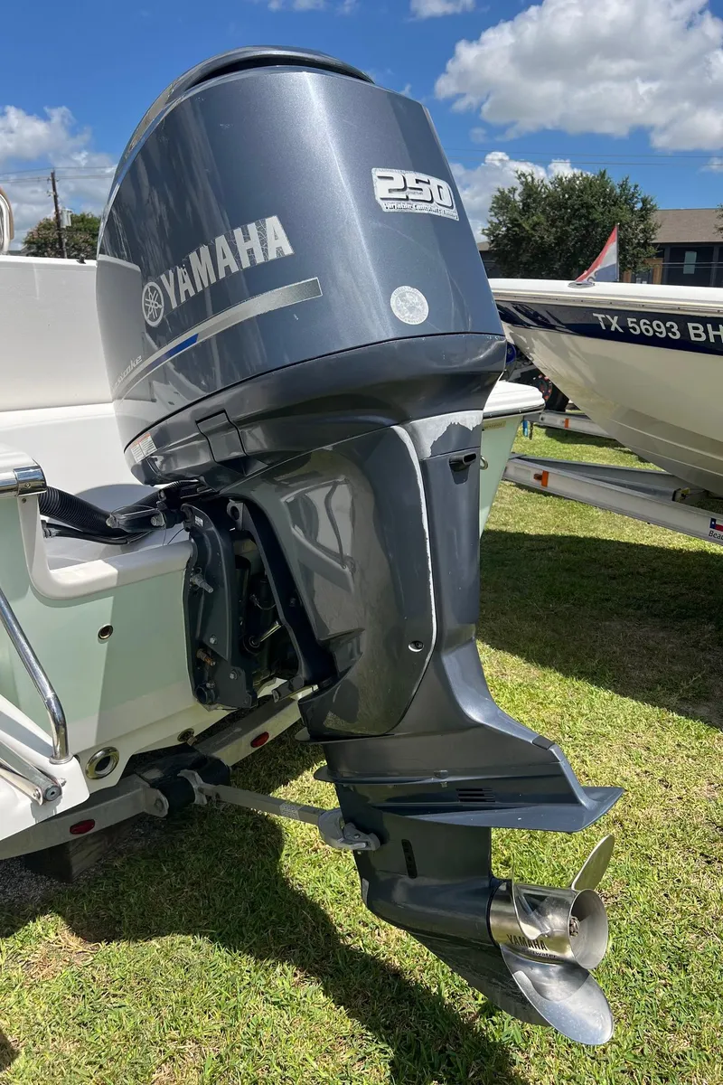Slide: The Image of Yamaha 250 outboard motor on a 2015 Sportsman Masters 247 Bay Boat, parked on grass. - 25