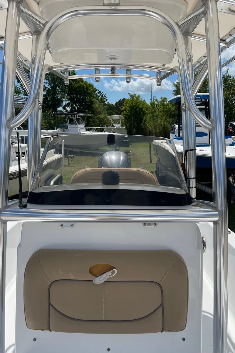 Slide: The Image of 2015 Sportsman Masters 247 Bay Boat with T-top and console, docked outdoors. - 29