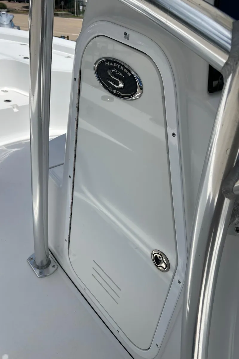 Slide: The Image of 2015 Sportsman Masters 247 Bay Boat console door with logo and stainless steel railing. - 31