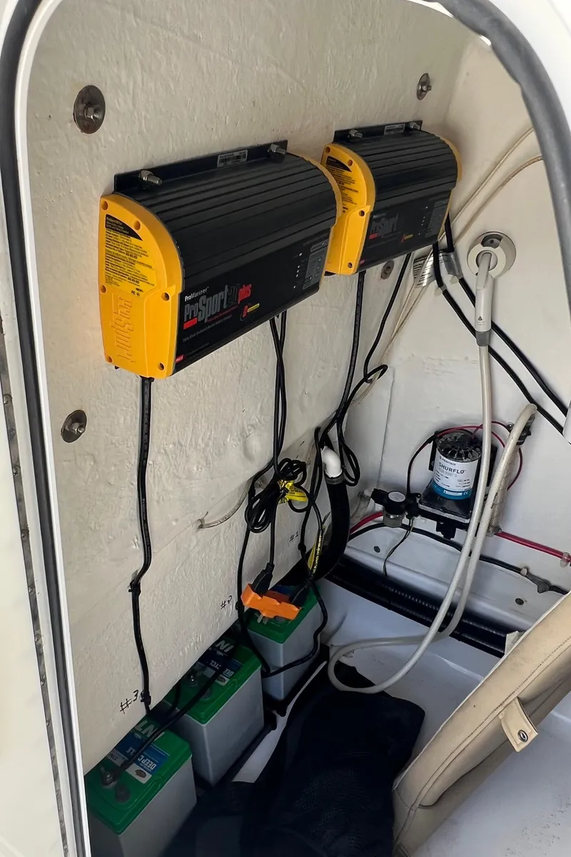 Slide: The Image of Battery compartment of a 2015 Sportsman Masters 247 Bay Boat with chargers and wiring. - 32