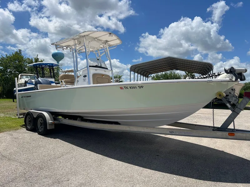 Slide: The Image of 2015 Sportsman Masters 247 Bay Boat on trailer under blue sky. - 5