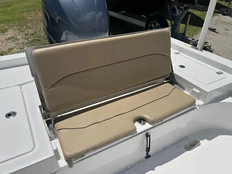 Slide: The Image of 2015 Sportsman Masters 247 Bay Boat with beige seating and storage compartments. - 7