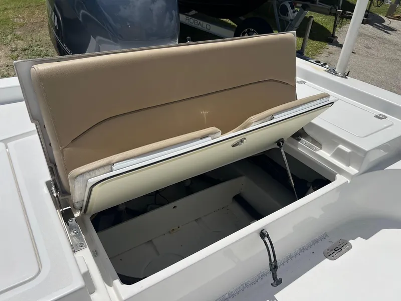 Slide: The Image of 2015 Sportsman Masters 247 Bay Boat with open storage compartment and beige seating. - 9