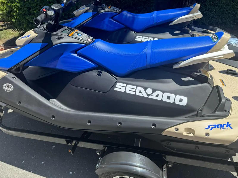 Slide: The Image of 2025 Sea-Doo SPARK TRIXX 3up jet ski with blue seats on a trailer. - 4