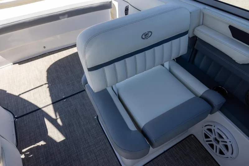 Slide: The Image of 2019 Cobalt 25SC boat interior with cushioned seating and carpeted flooring. - 12