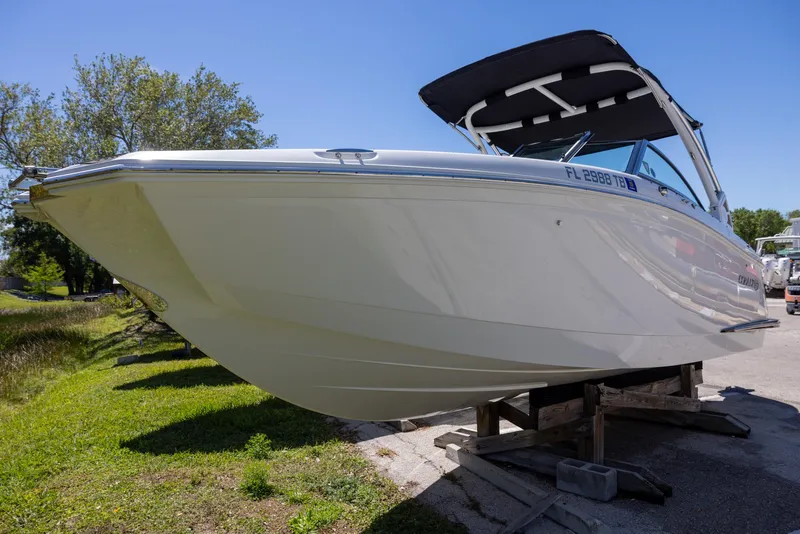 Slide: The Image of 2019 Cobalt 25SC boat on display, featuring sleek design and black canopy. - 2