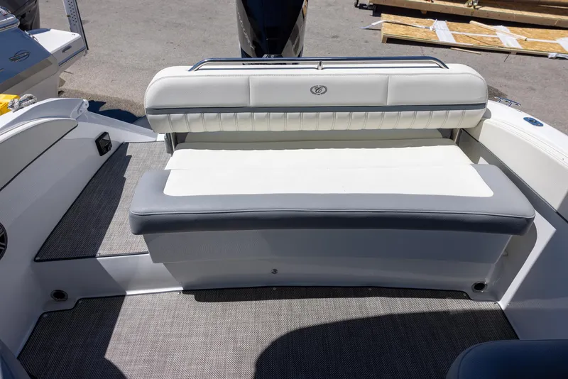 Slide: The Image of 2019 Cobalt 25SC boat interior with cushioned seating and textured flooring. - 7