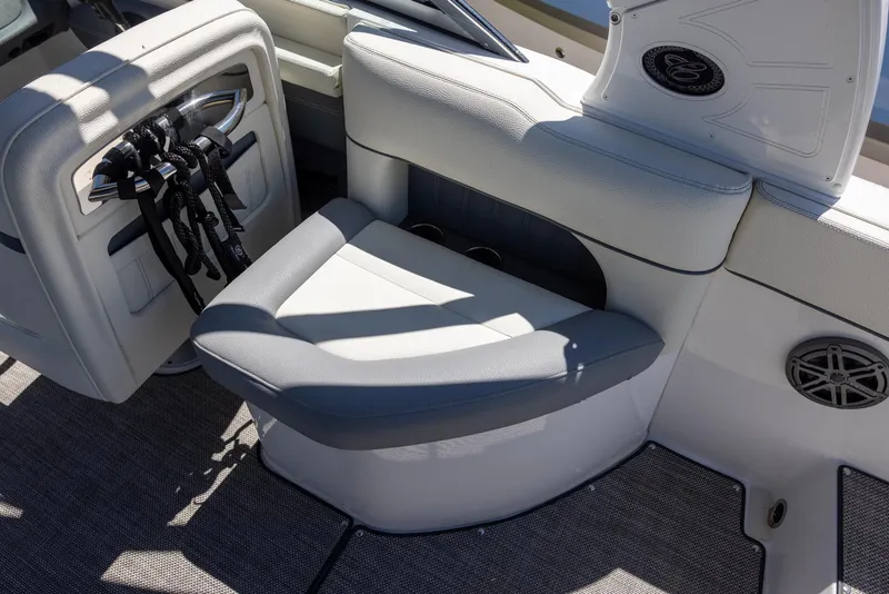 Slide: The Image of 2019 Cobalt 25SC boat interior with cushioned seating and speaker system. - 8