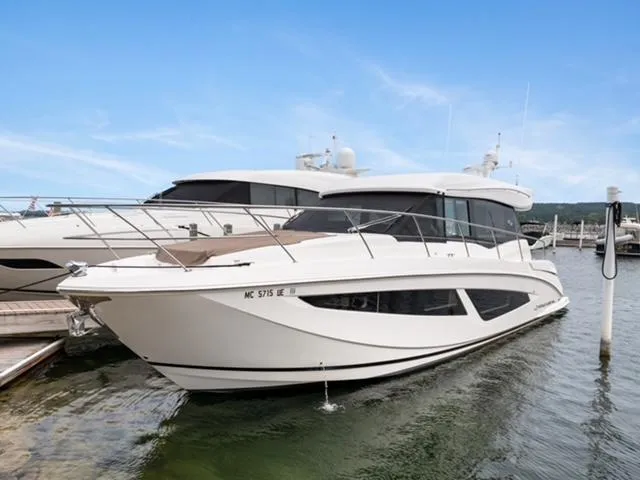 The Image of 2017 Regal 42 Grande Coupe yacht docked in marina, showcasing sleek design and luxury features. - 0