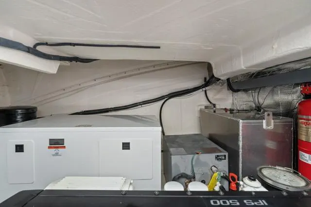 Slide: The Image of Engine room of 2017 Regal 42 Grande Coupe with generator and fire extinguisher. - 18