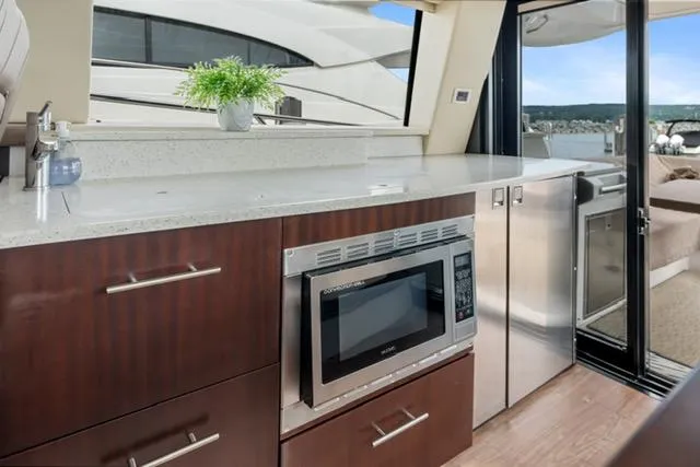 Slide: The Image of Luxurious 2017 Regal 42 Grande Coupe yacht interior with modern kitchen amenities. - 19