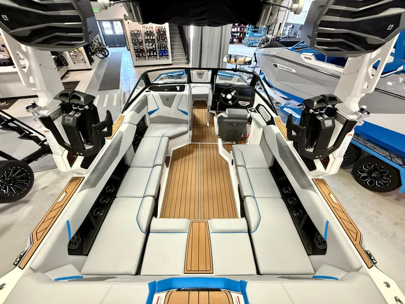 Slide: The Image of 2025 Nautique Super Air Nautique S23 interior with sleek seating and modern design in showroom. - 10