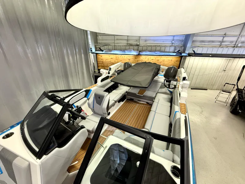 Slide: The Image of 2025 Nautique Super Air Nautique S23 boat interior with sleek seating and modern design. - 13