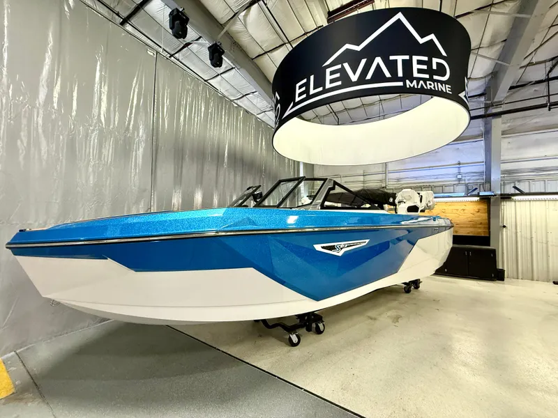 Slide: The Image of 2025 Nautique Super Air Nautique S23 boat displayed indoors at Elevated Marine showroom. - 15