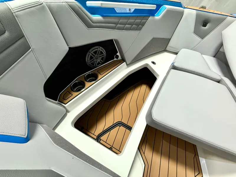 Slide: The Image of 2025 Nautique Super Air Nautique S23 interior with sleek seating, cup holders, and stylish flooring. - 20