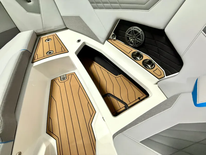 Slide: The Image of 2025 Nautique Super Air Nautique S23 interior with sleek seating and stylish wood accents. - 23
