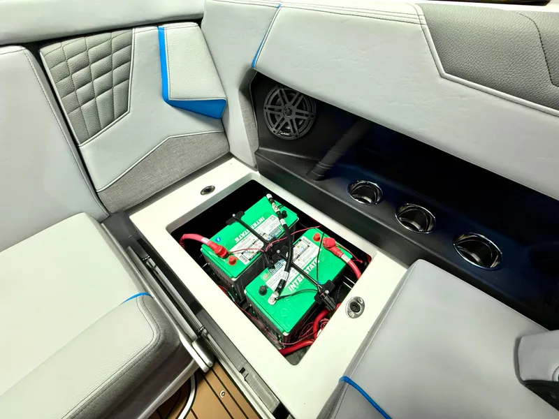 Slide: The Image of 2025 Nautique Super Air Nautique S23 interior with battery compartment and speaker. - 27