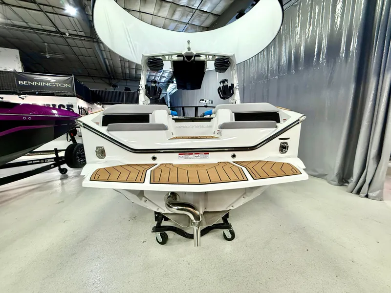 Slide: The Image of 2025 Nautique Super Air Nautique S23 boat displayed indoors, rear view. - 3