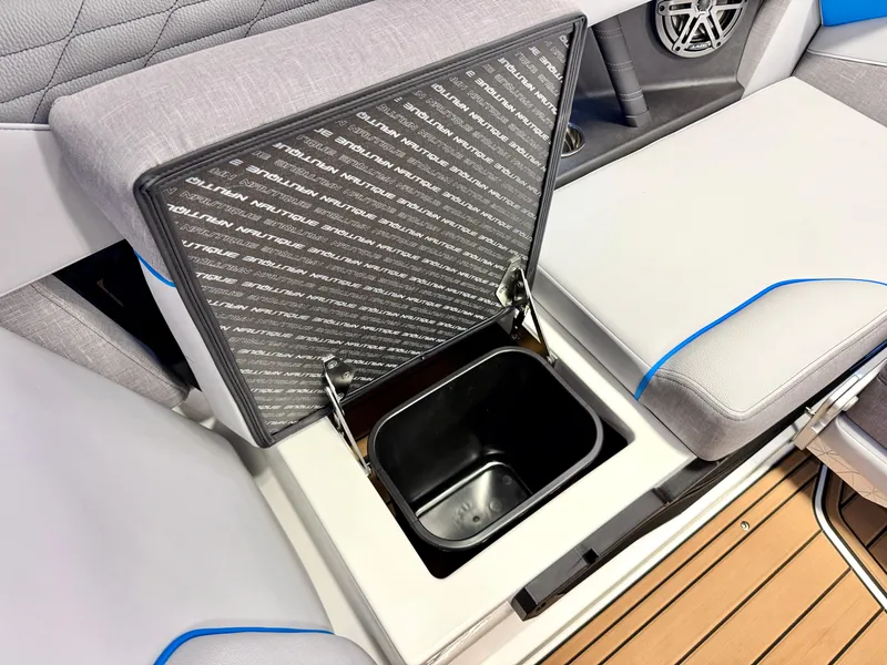 Slide: The Image of 2025 Nautique Super Air Nautique S23 boat interior with open storage compartment. - 32