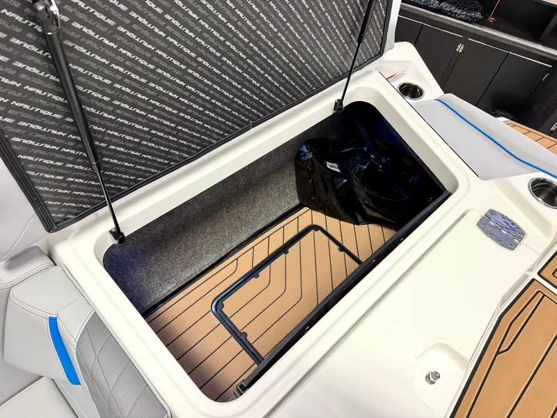 Slide: The Image of 2025 Nautique Super Air Nautique S23 storage compartment with open lid, showcasing interior design. - 35
