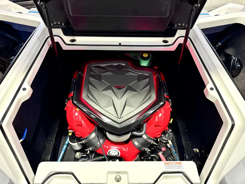 Slide: The Image of 2025 Nautique Super Air Nautique S23 engine compartment with red and black engine cover. - 37