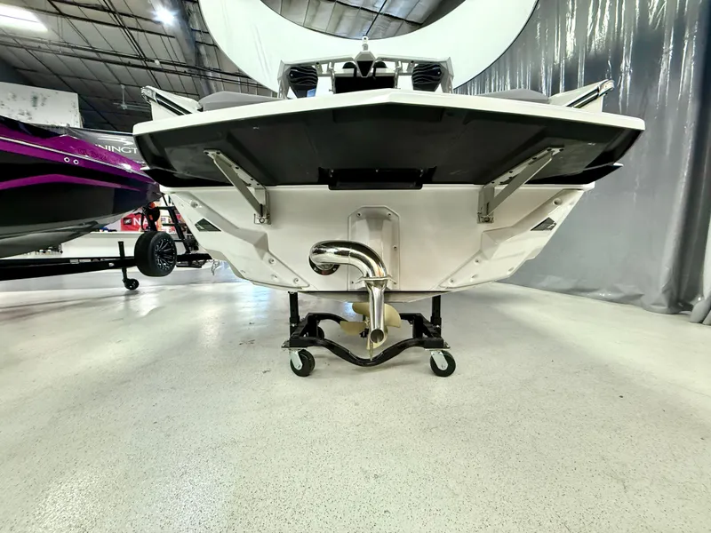 Slide: The Image of 2025 Nautique Super Air Nautique S23 boat on display in a showroom. - 4