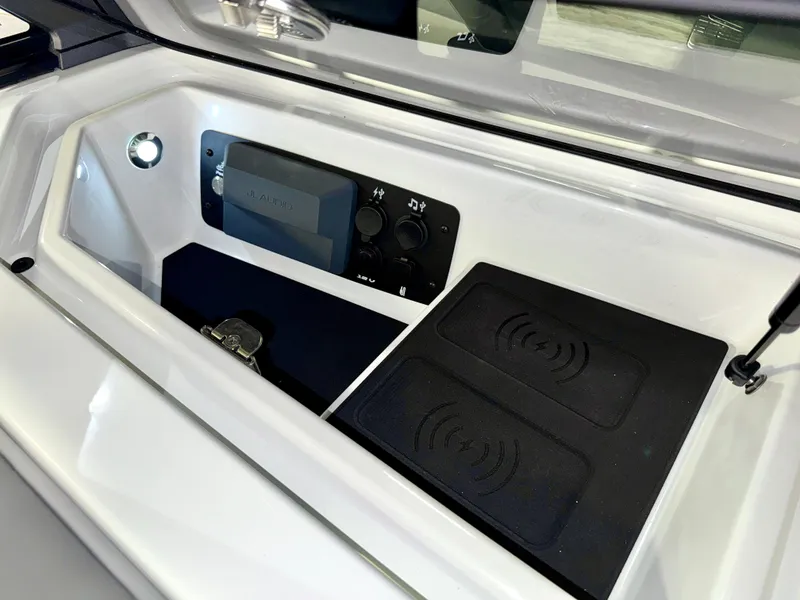 Slide: The Image of 2025 Nautique Super Air Nautique S23 audio control panel and wireless charging pads. - 46