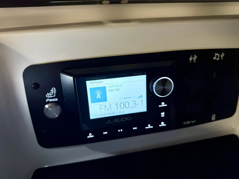 Slide: The Image of 2025 Nautique Super Air Nautique S23 audio system displaying FM radio station. - 47